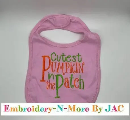 Pink baby bib with 'Cutest Pumpkin in the Patch' embroidered in orange and green text.