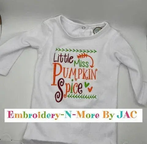 White baby onesie with colorful embroidered text 'Little Miss Pumpkin Spice' and leaf accents