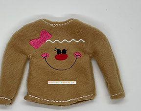 Brown felt doll sweater with embroidered gingerbread face, pink bow, and decorative stitching