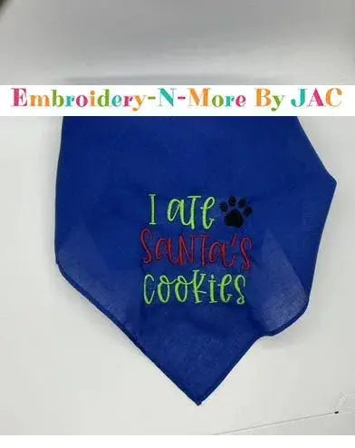 Blue pet bandana with embroidered 'I ate Santa's cookies' and a paw print, holiday accessory.