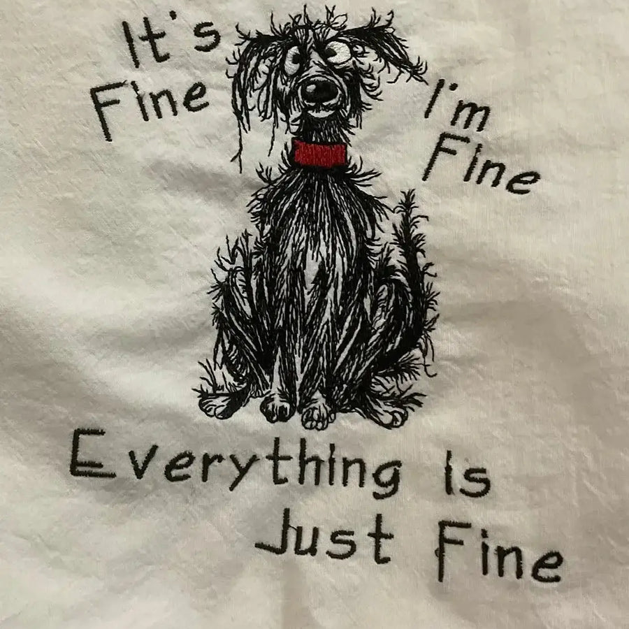 Embroidered kitchen towel with scruffy dog illustration and humorous saying, "It's fine, I'm fine, everything is just fine."