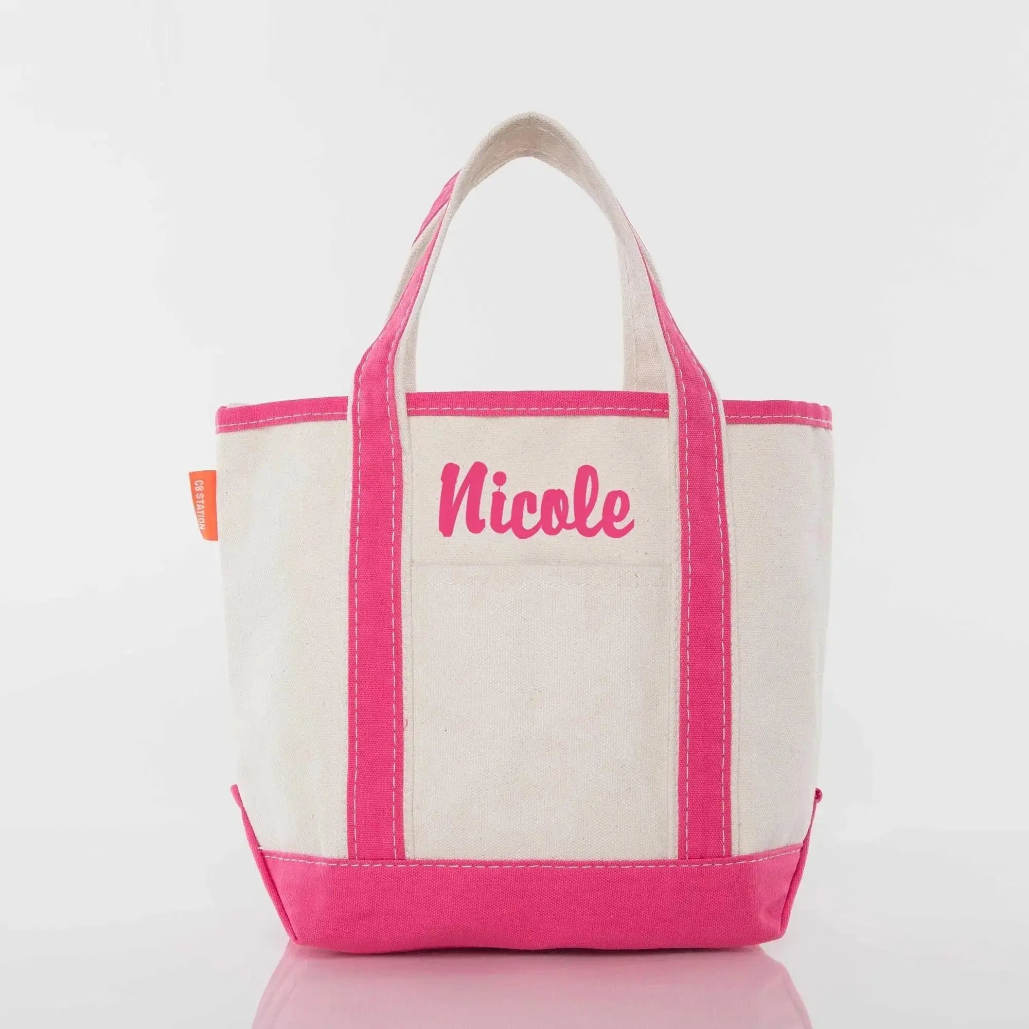 Personalized canvas tote bag with pink trim and 'Nicole' embroidered on front pocket