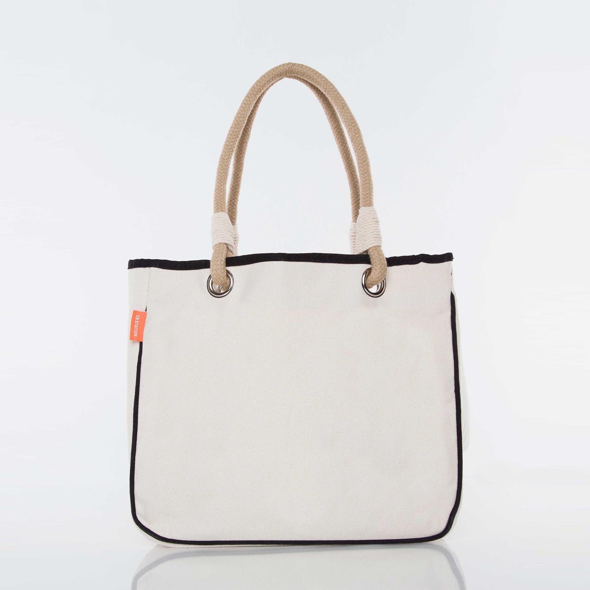 Canvas tote bag with rope handles and black trim on a white background