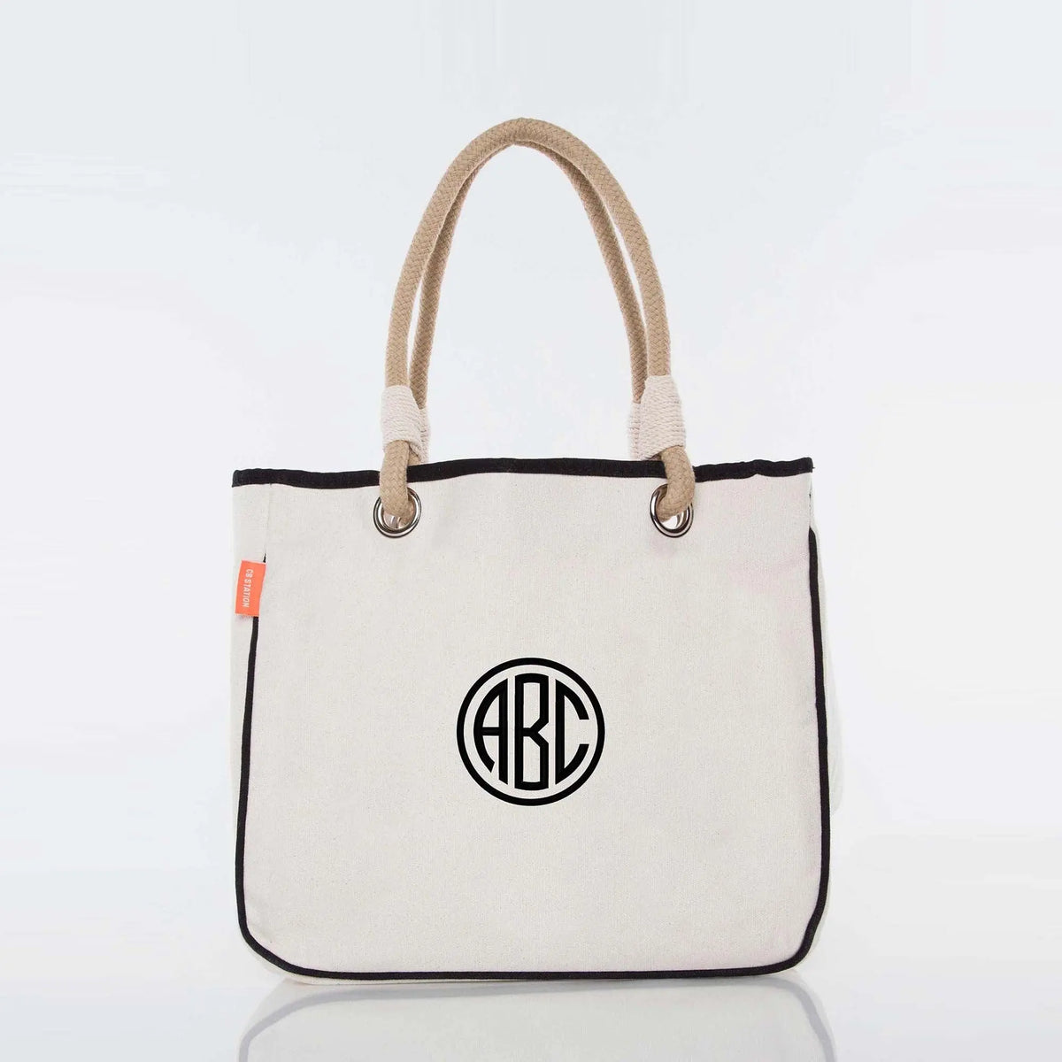 Personalized canvas tote bag with rope handles and black circle monogram design