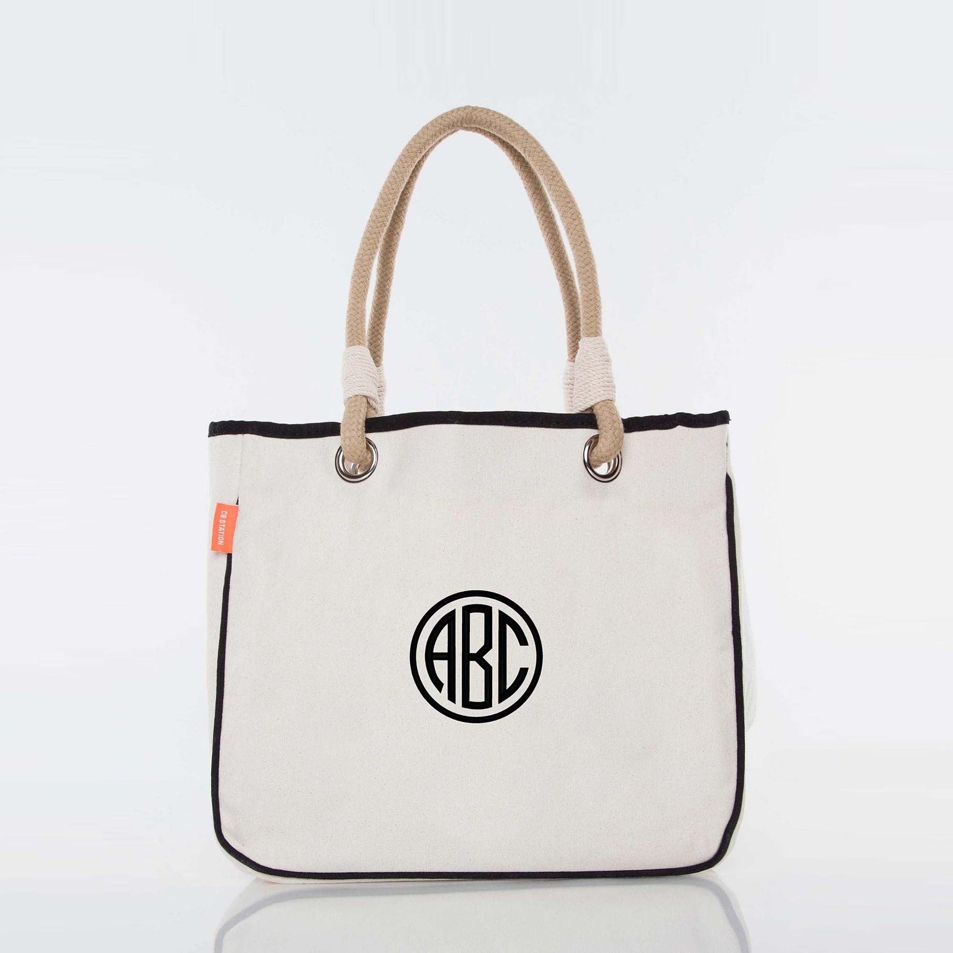 Personalized canvas tote bag with rope handles and embroidered monogram initials on front