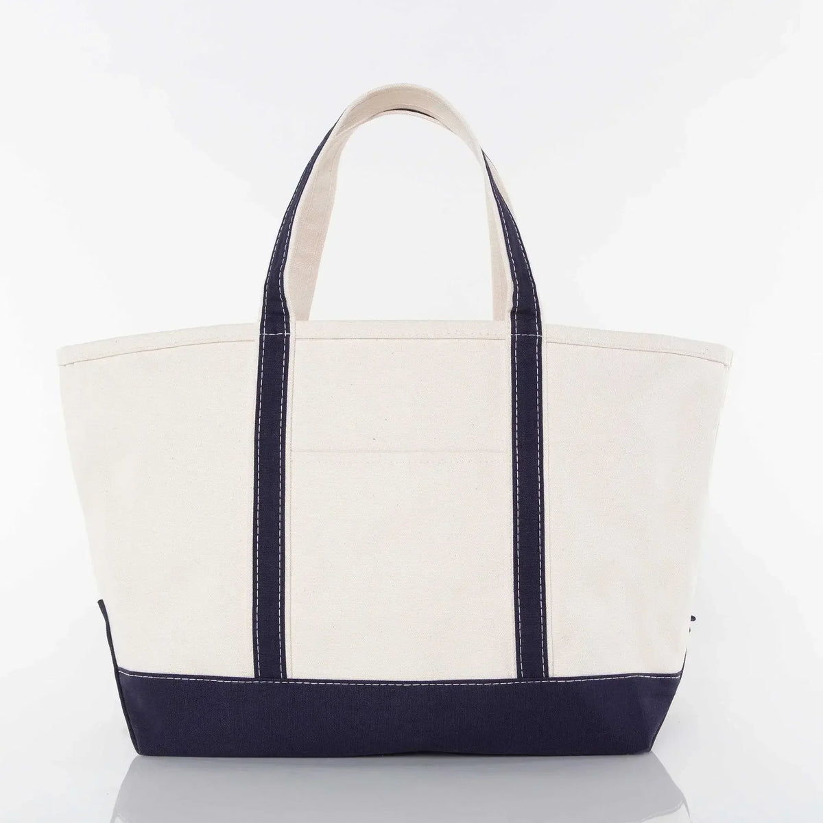 Large canvas tote bag with navy blue handles and bottom, plain front, white background
