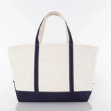 Large canvas tote bag with navy blue handles and bottom, plain front, white background