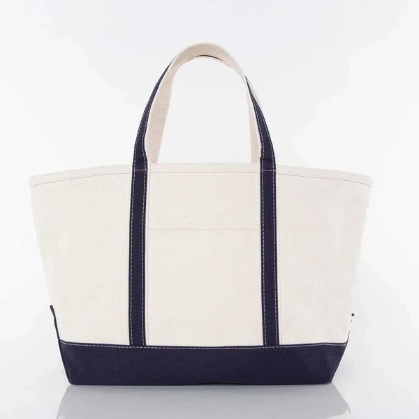Large canvas tote bag with navy blue handles and bottom, plain front, white background