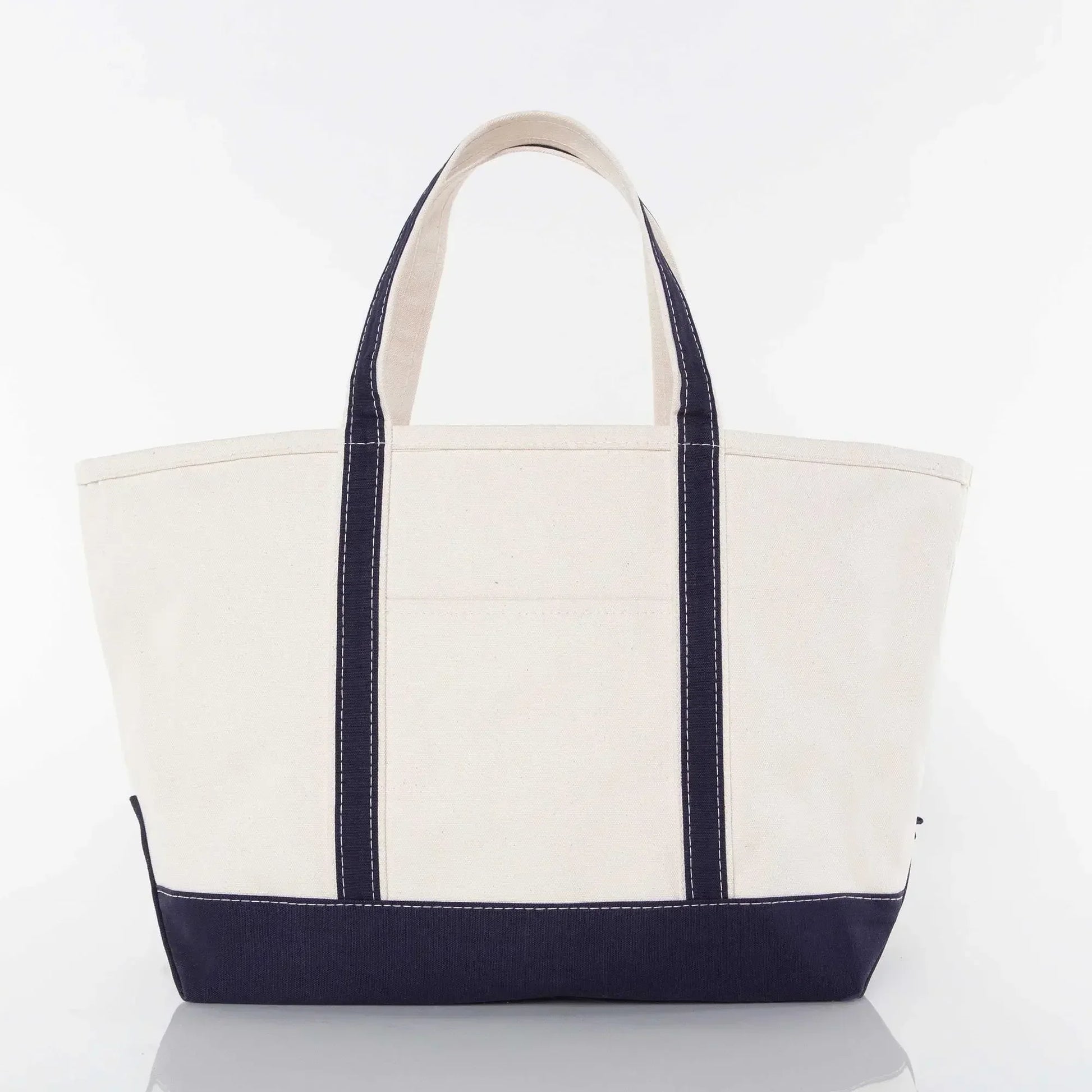 Large canvas tote bag with navy blue handles and bottom, plain front, white background