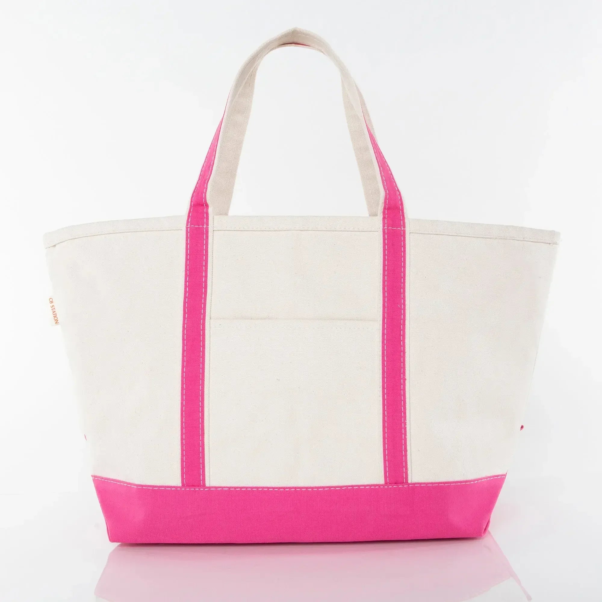 Canvas tote bag with pink handles and trim, front pocket, on a white background.