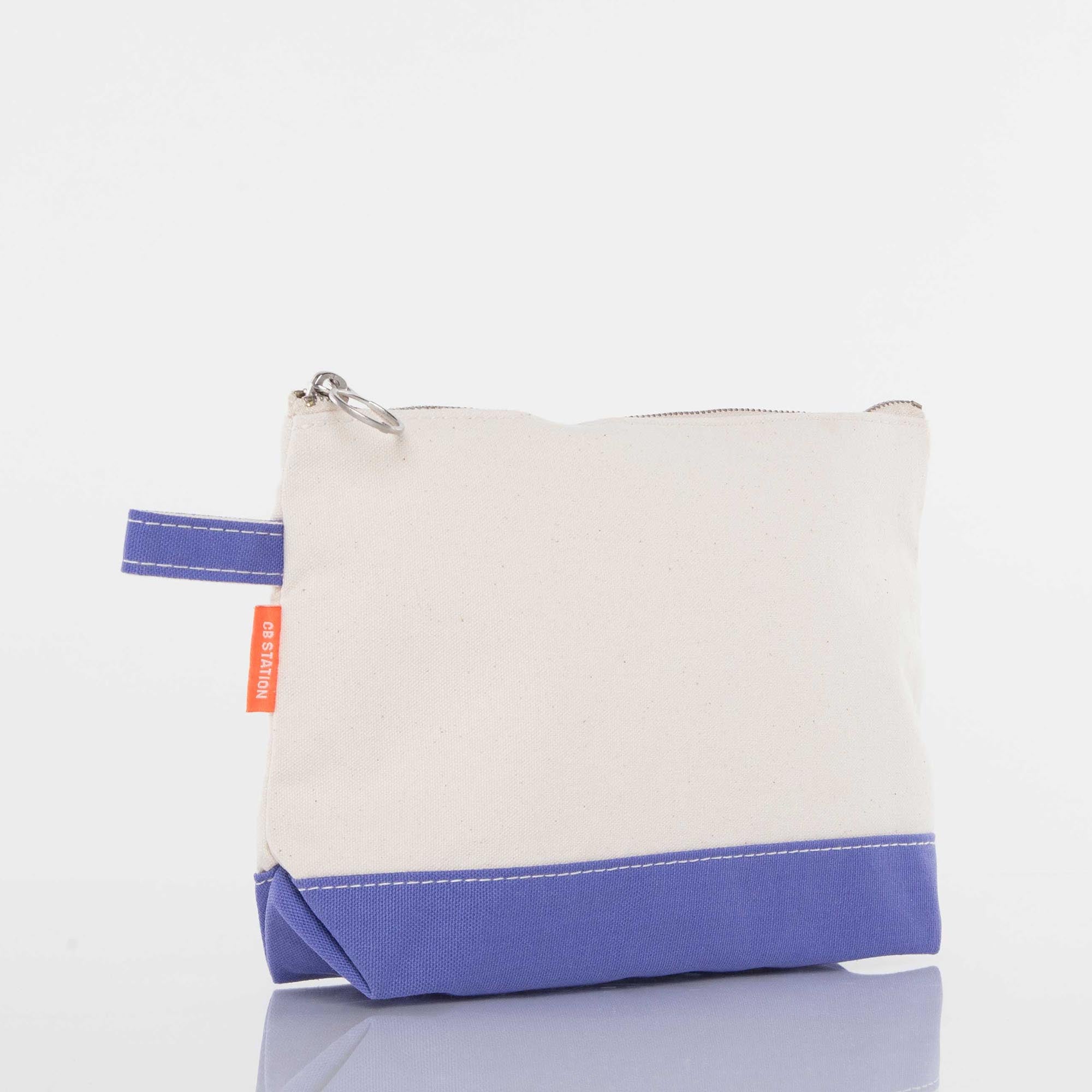 Canvas zipper pouch with cream body, purple base, and key ring loop