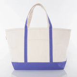 Large canvas tote bag with purple base, purple handles, and front pocket on white background