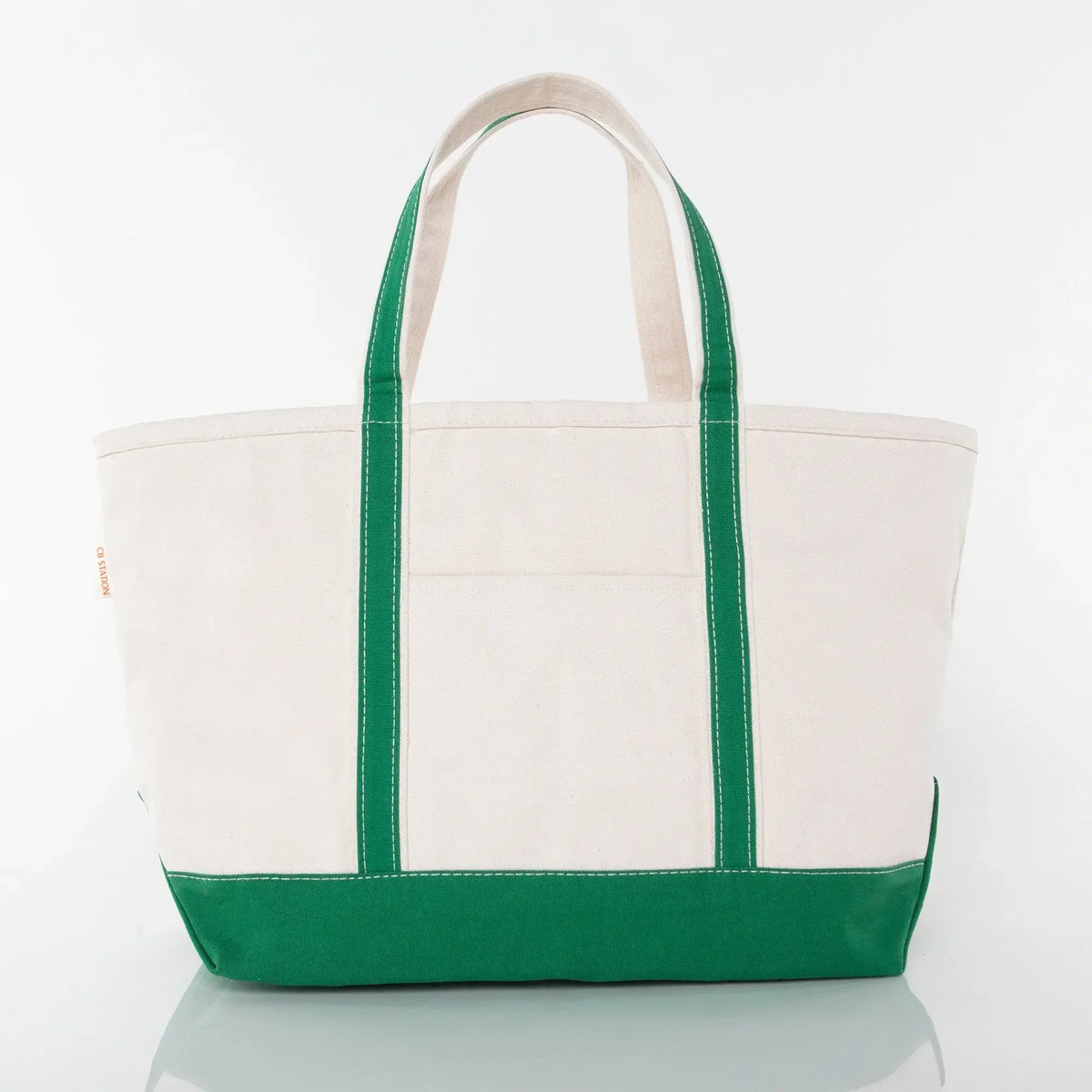 Canvas tote bag with green handles and bottom, large utility pocket, white background.