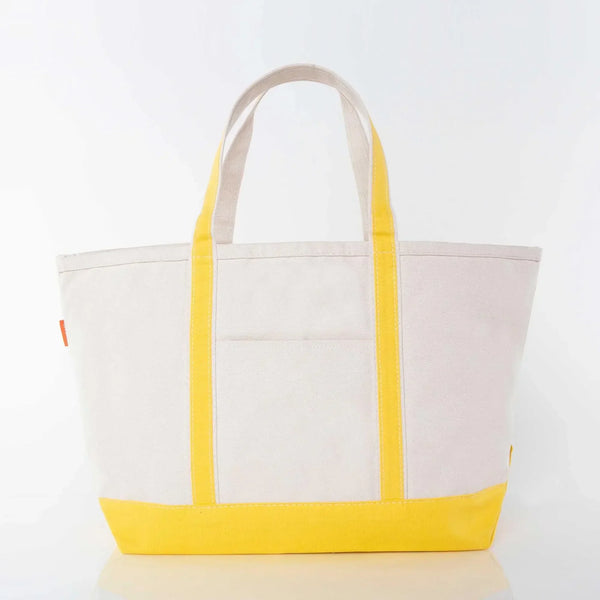 Canvas tote bag with yellow handles and base, front pocket, on white background