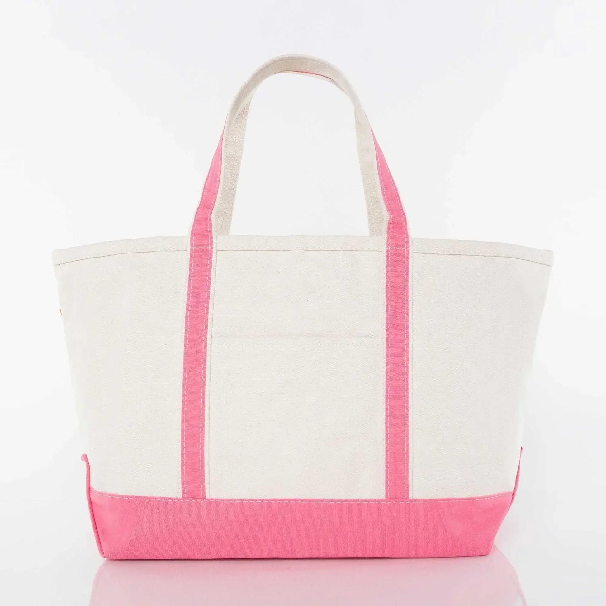 Canvas tote bag with pink handles and trim on a white background
