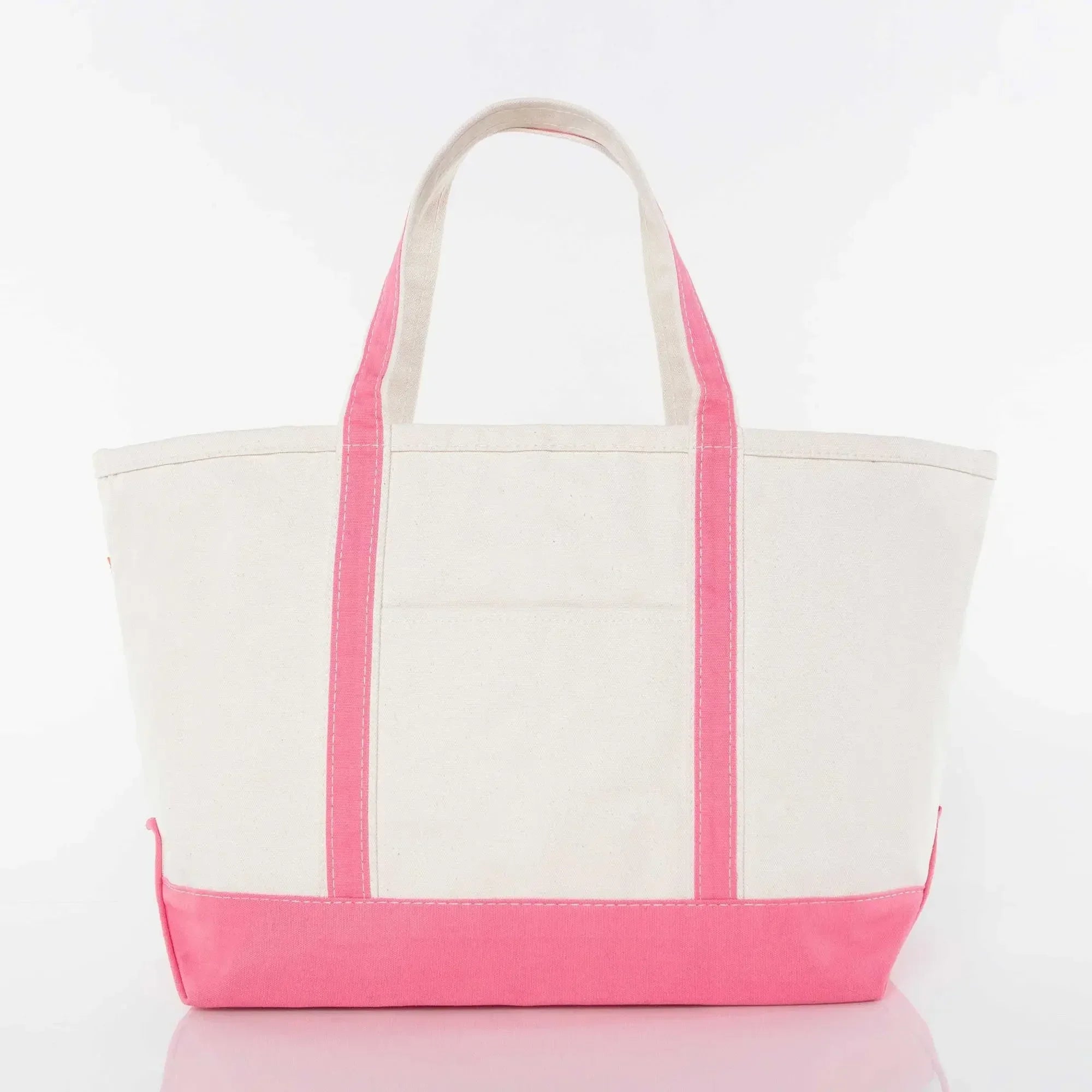 Canvas tote bag with pink handles and trim on a white background
