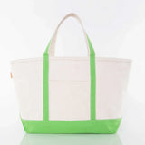 Canvas tote bag with green handles and base, front pocket, on white background