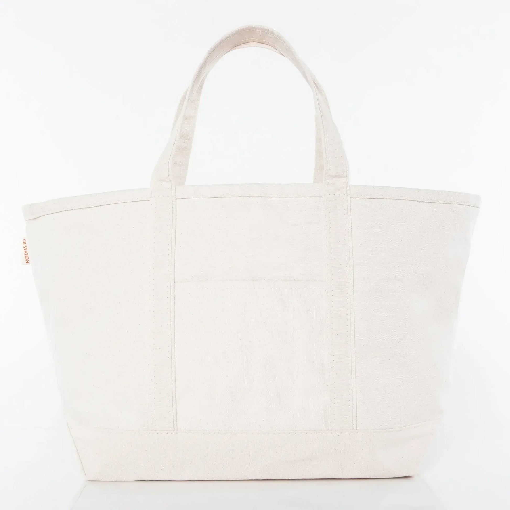 Large plain canvas tote bag with front pocket and two handles, ideal for custom embroidery.