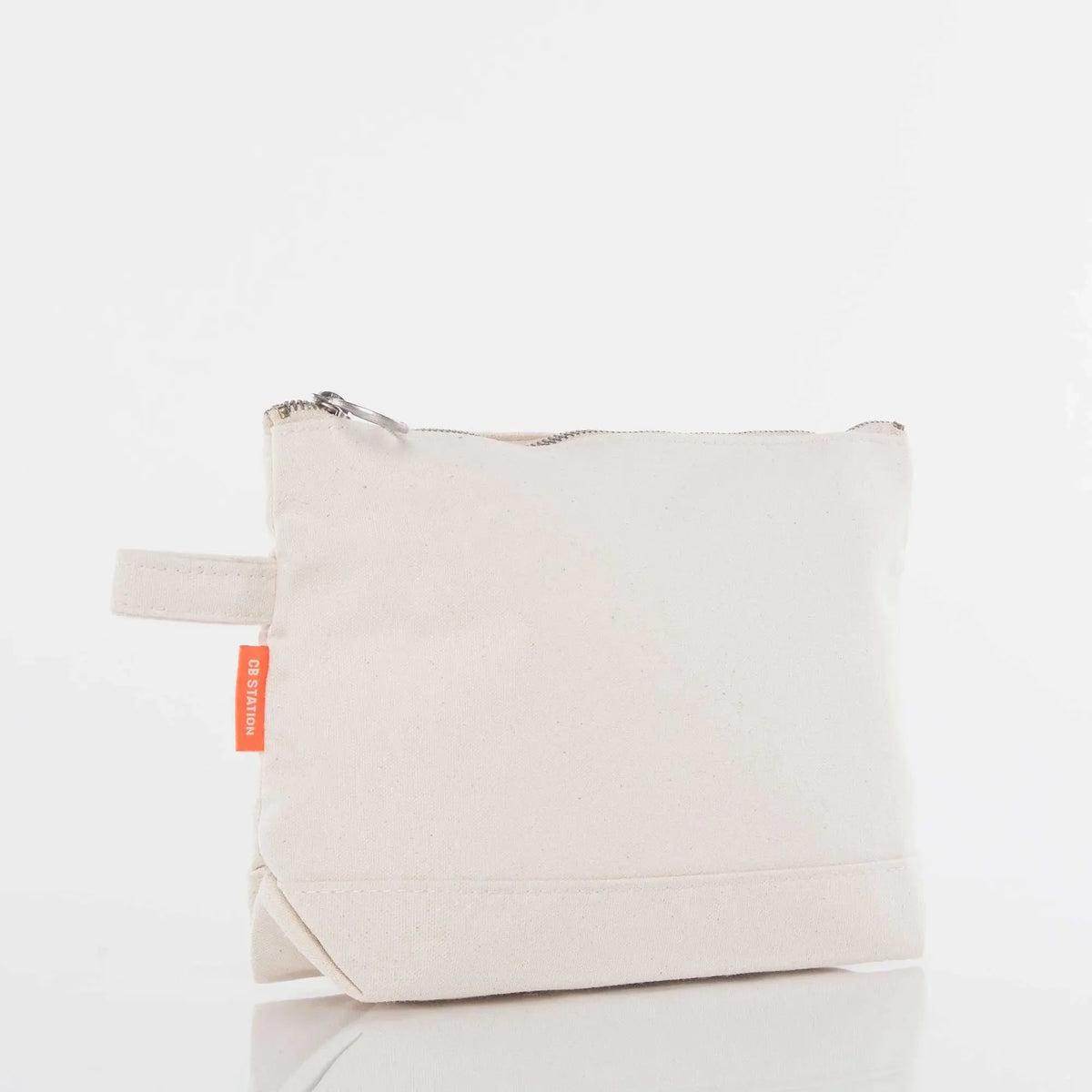 Natural canvas zippered pouch with side loop and orange tag, blank and ready for embroidery