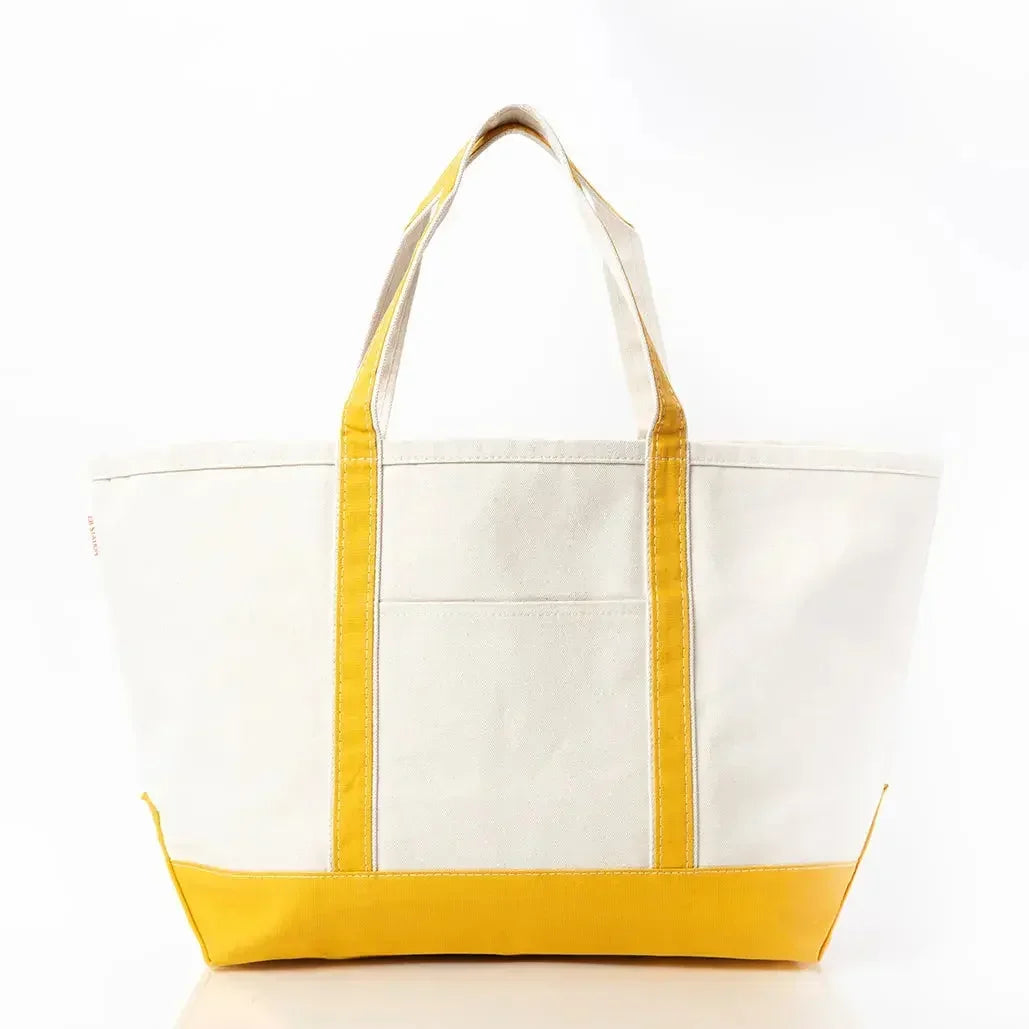 Large canvas tote bag with yellow handles and base, front pocket, on white background