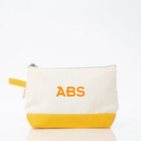 Personalized canvas makeup bag with yellow base and ABS monogram in orange lettering