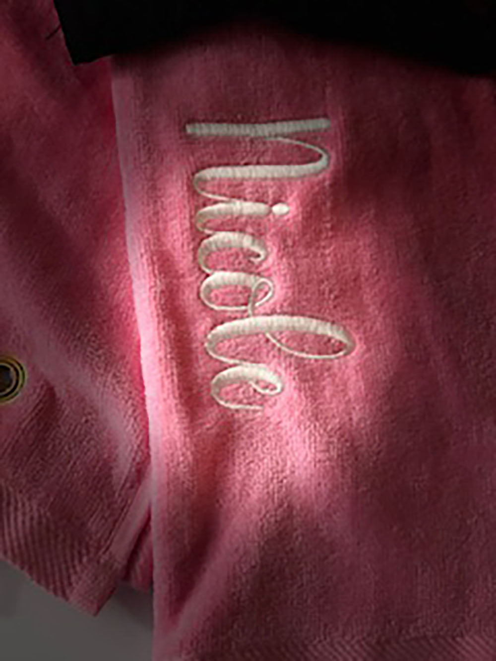 Pink fabric with 'Nicole' embroidered in white thread