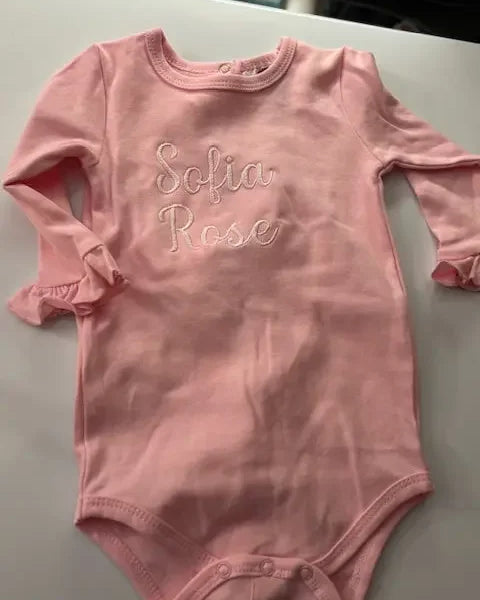 Personalized pink baby bodysuit with embroidered name Sofia Rose, long sleeves, snap closure