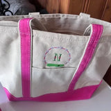 Personalized canvas tote bag with pink handles and embroidered monogram M