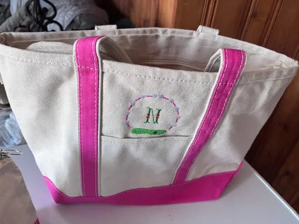 Personalized canvas tote bag with pink handles and embroidered monogram M