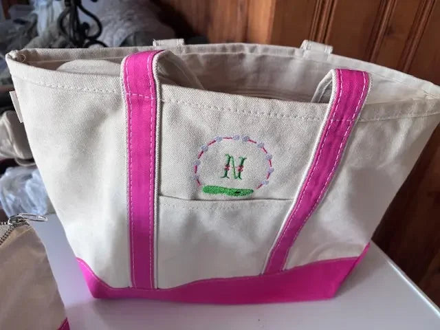 Personalized canvas tote bag with pink accents and embroidered initial M