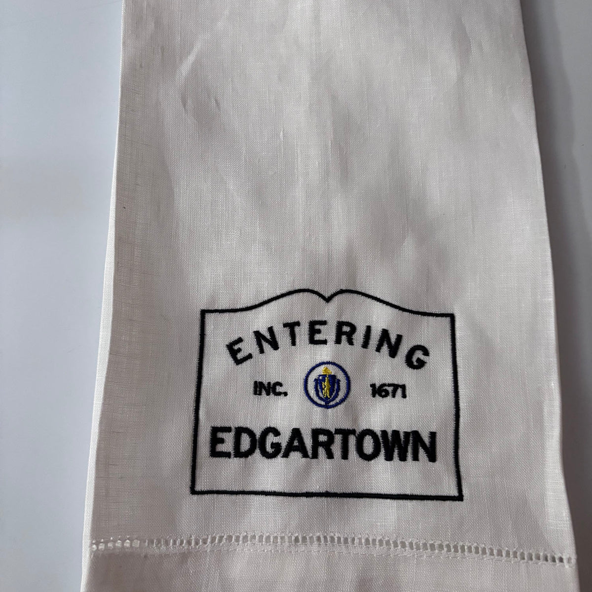 Linen hemsttiched kitchen towel embroidered with Entering Edgartown town sirn