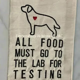Embroidered kitchen towel with dog outline, heart detail, buffalo plaid border, and food testing quote