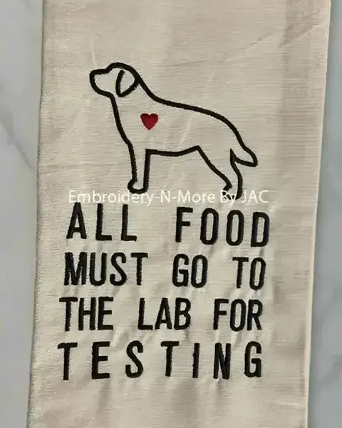 Embroidered kitchen towel with dog outline, heart detail, buffalo plaid border, and food testing quote