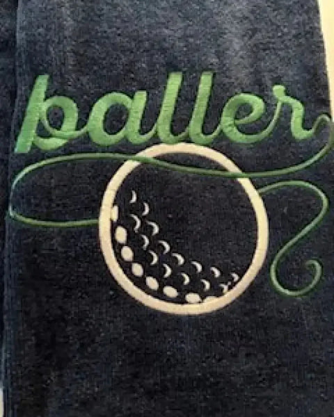 Embroidered golf towel with green baller text and white golf ball design