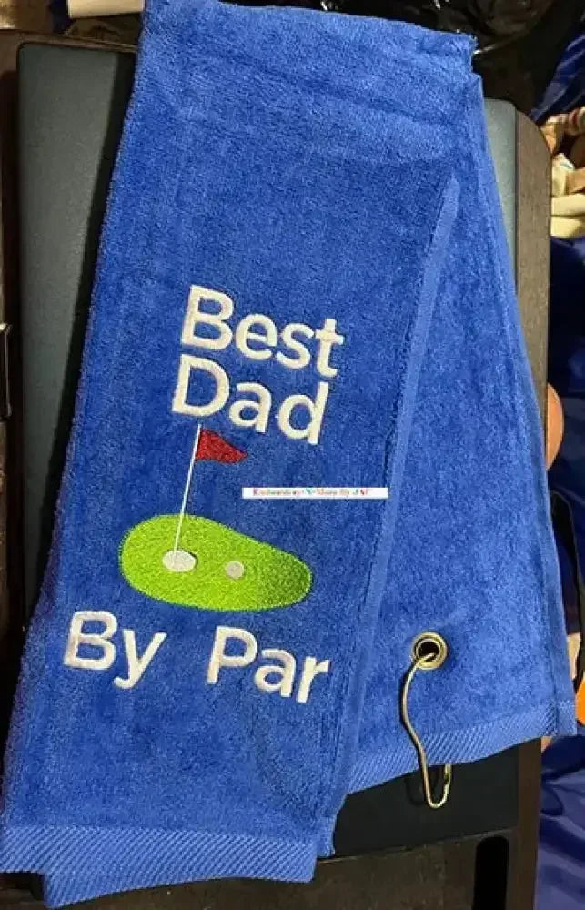 Blue tri-fold golf towel with 'Best Dad By Par' embroidered text and golf green design.