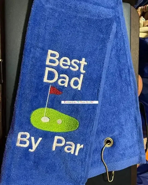 Blue tri-fold golf towel with 'Best Dad By Par' embroidered text and golf green design.