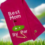 Pink embroidered golf towel with 'Best Mom by Par' text, golf green graphic, and two tees