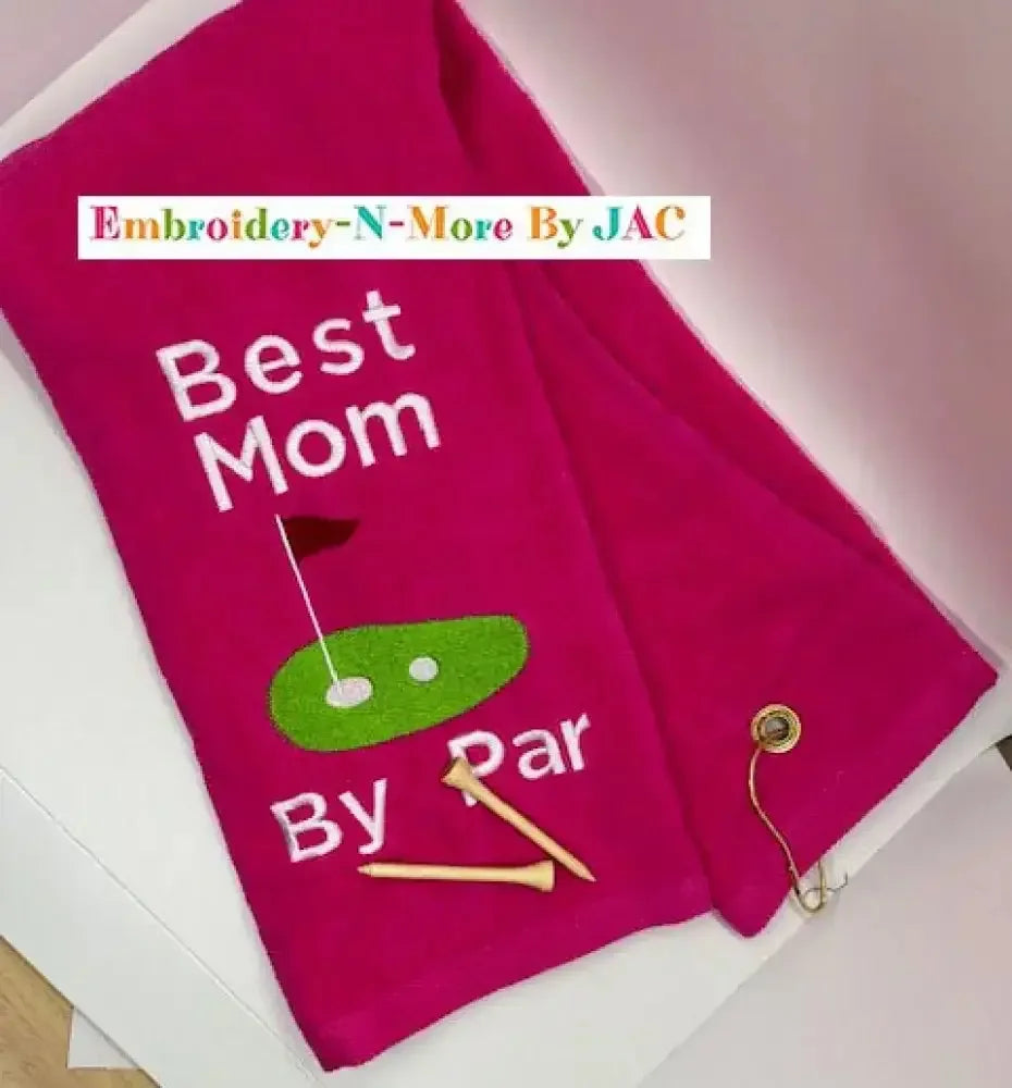 Pink embroidered golf towel with 'Best Mom By Par', golf tees, and putting green design.