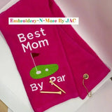 Pink embroidered golf towel with 'Best Mom By Par', golf tees, and putting green design.