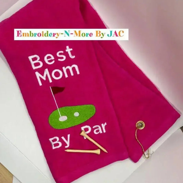 Pink embroidered golf towel with 'Best Mom By Par', golf tees, and putting green design.