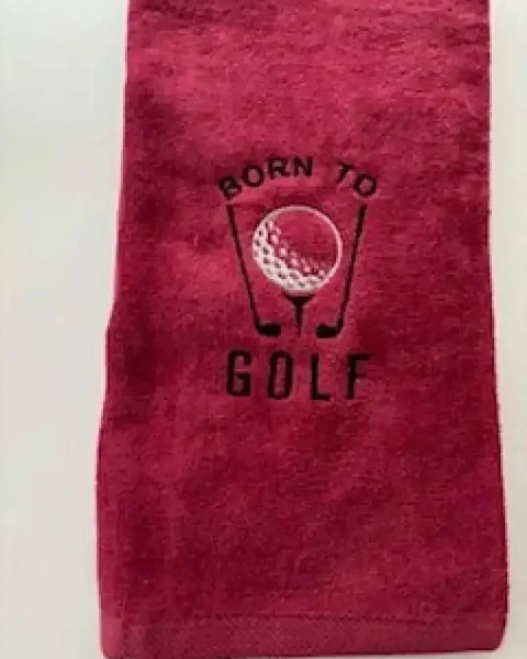 Red embroidered golf towel with 'Born to Golf' text and golf ball design