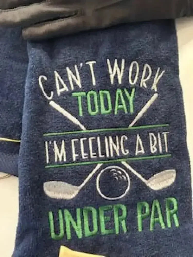 Embroidered navy golf towel with crossed clubs, golf ball, and humorous text design