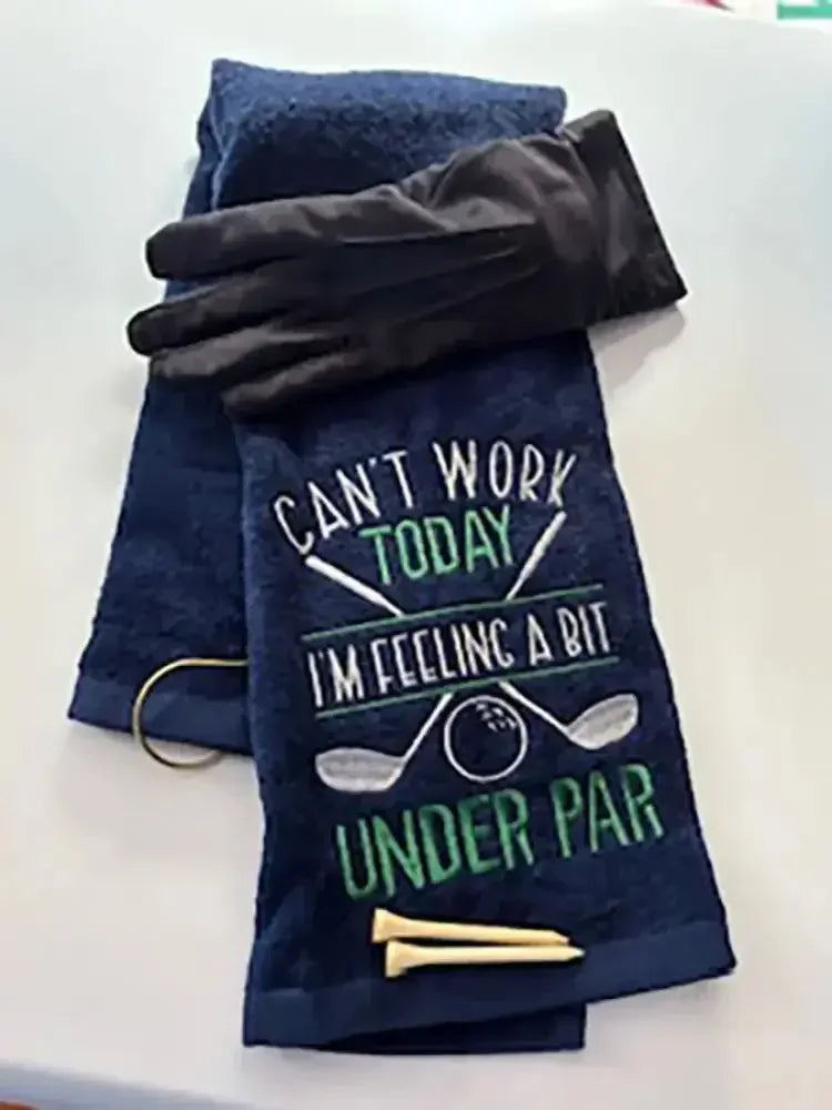 Navy embroidered golf towel with humorous 'Can't Work Today I'm Feeling Under Par' text, glove, and tees