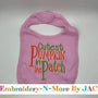 Pink baby bib with 'Cutest Pumpkin in the Patch' embroidered in orange and green letters