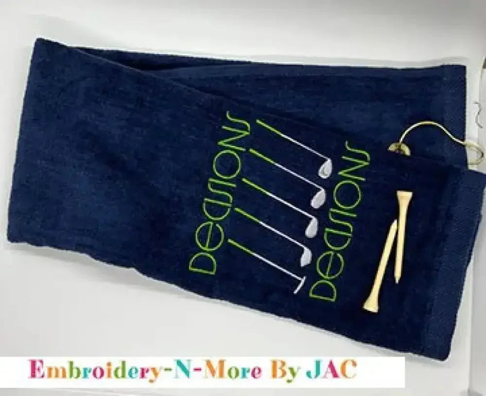 Navy tri-fold golf towel with embroidered green 'Decisions' text, golf clubs, and tees