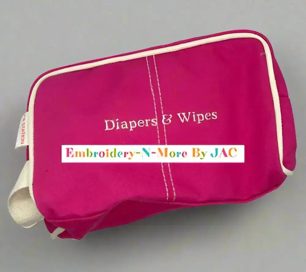 Pink diaper and wipes case bag with embroidered text, zip closure, and white trim.