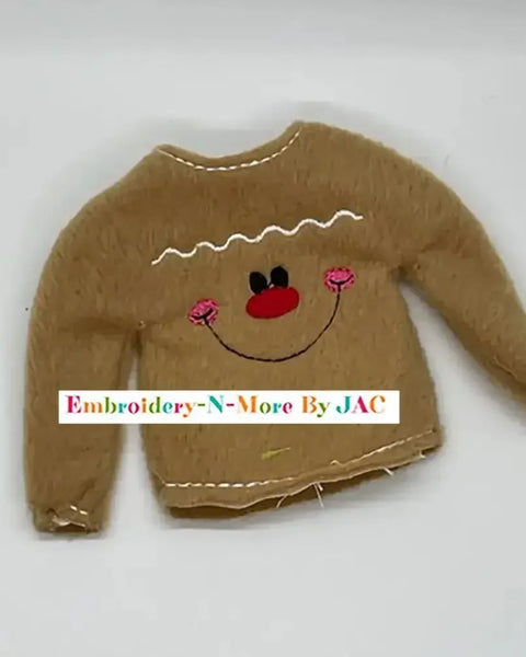 Brown embroidered gingerbread boy sweater with smiling face and pink cheeks, holiday accessory
