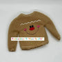 Brown embroidered gingerbread boy sweater with smiling face and pink cheeks, holiday accessory