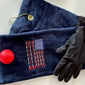 Navy golf towel with embroidered USA flag made from golf tees, red golf ball, and black glove