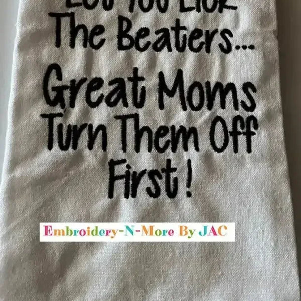White flour sack kitchen towel with humorous embroidered text and black plaid border.